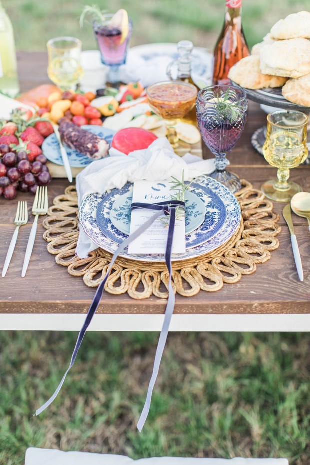 Elegant picnic table setting with food and decorations
