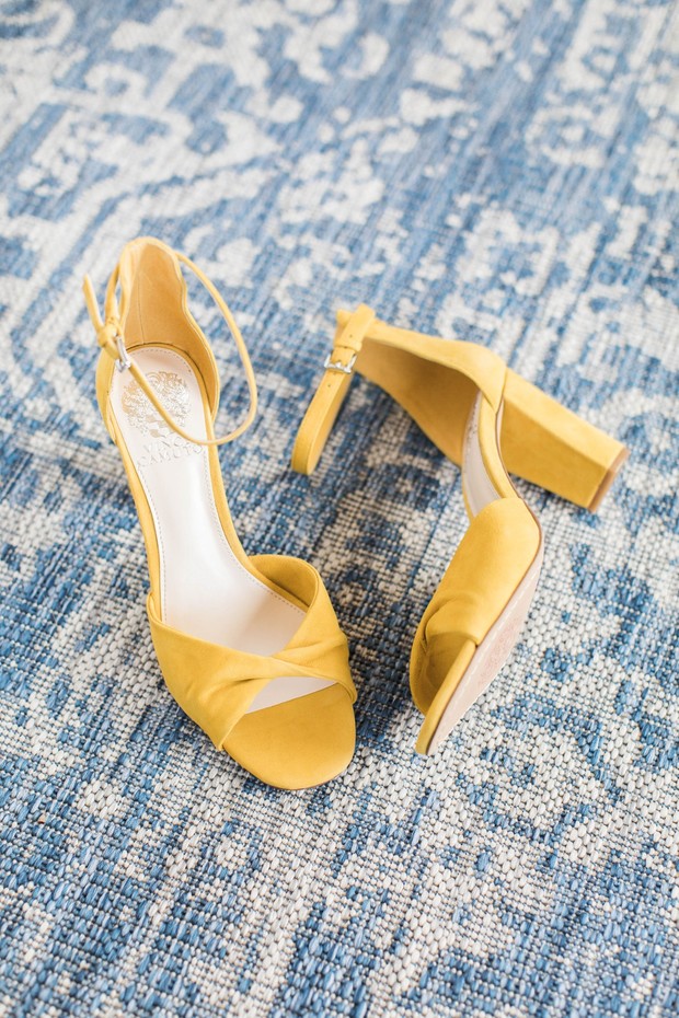 Elegant yellow ankle strap heeled sandals on blue rug