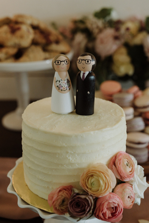 Wedding cake with wooden bride and groom toppers