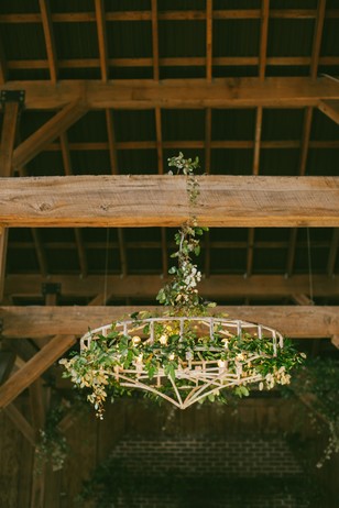 Floral chandelier in rustic barn venue setting