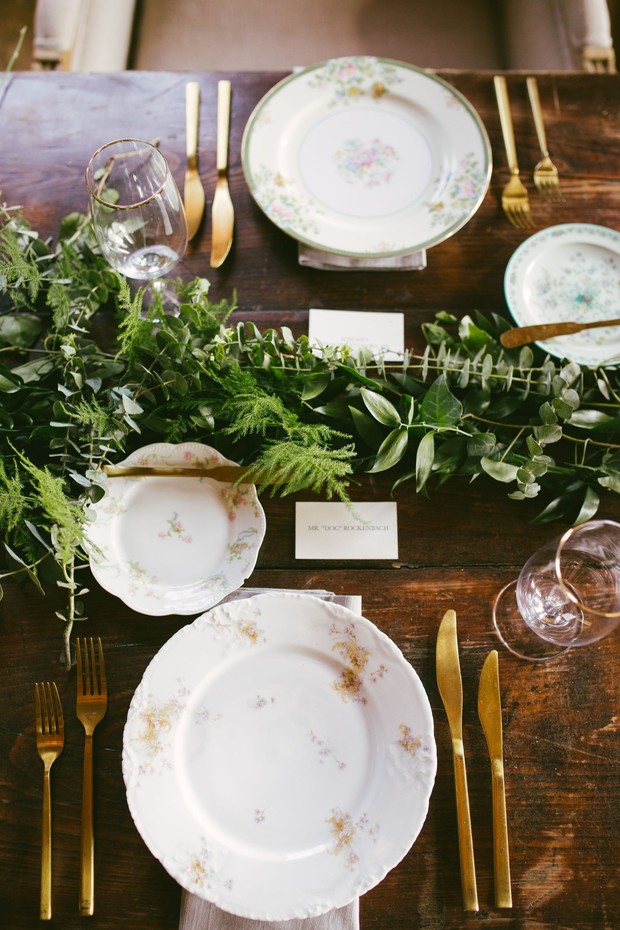 Elegant table setting with floral plates and gold flatware