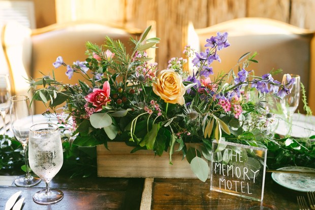 Rustic wedding table with flower box and The Memory Motel sign
