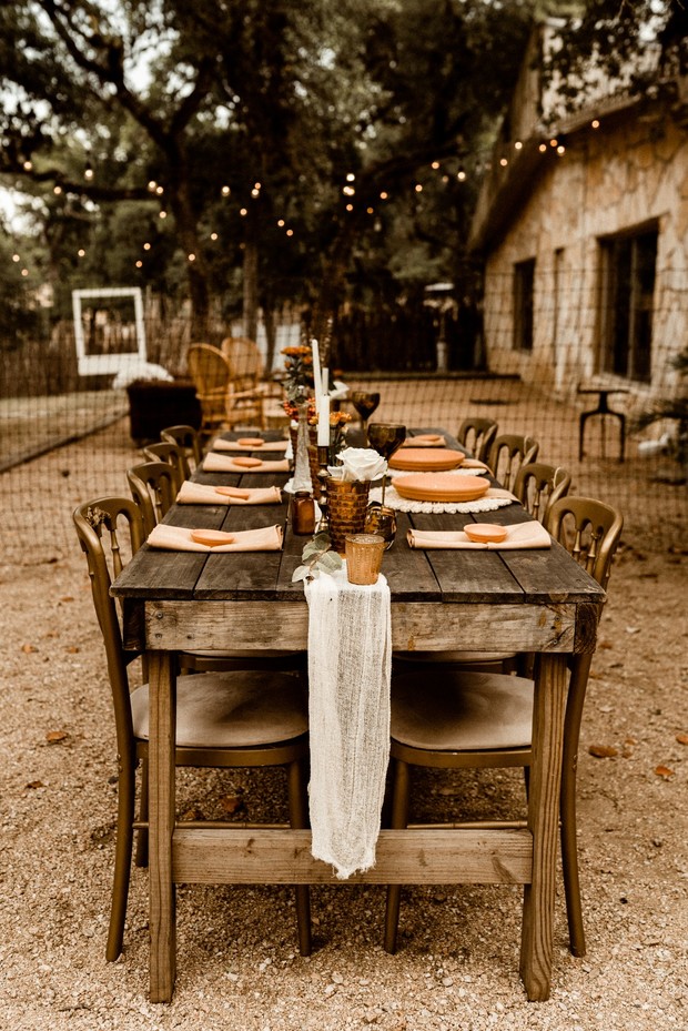 Rustic outdoor dining table setting with string lights