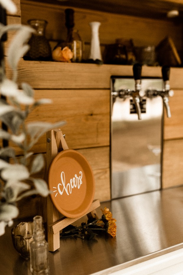 Cheers sign on rustic wooden bar backdrop