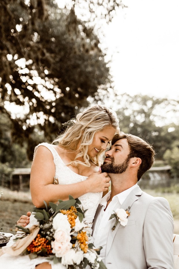 Happy bride and groom embrace outdoors wedding day