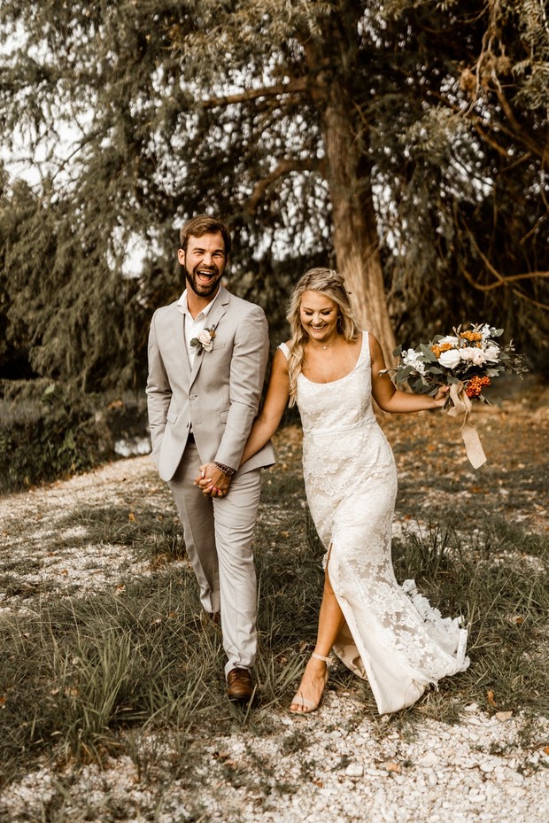 Happy bride and groom walking after wedding ceremony