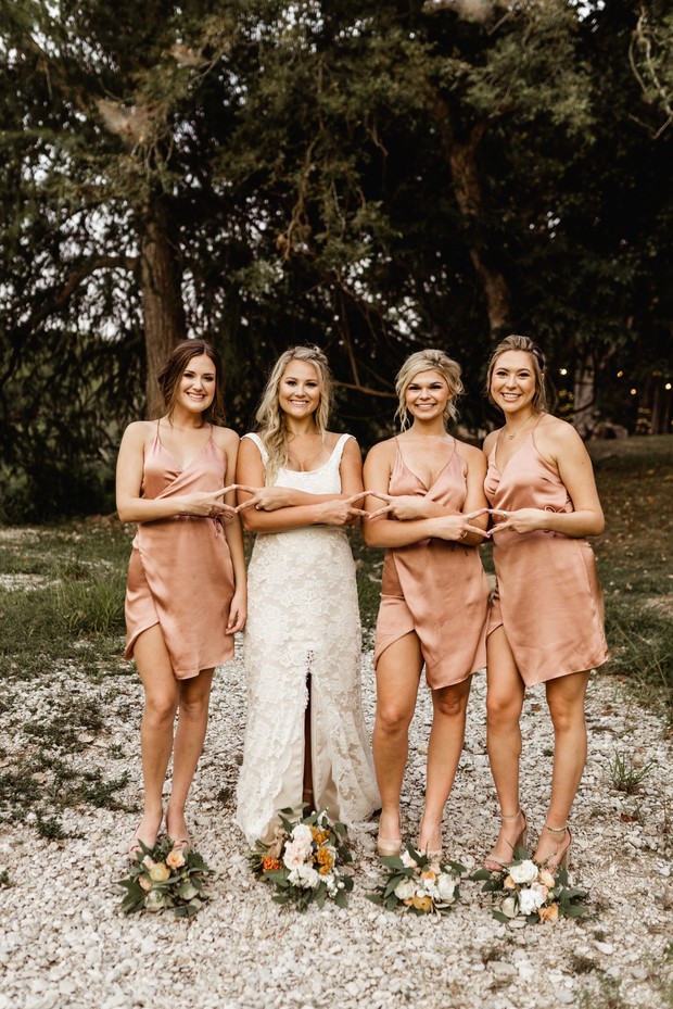 Bride and bridesmaids in rose gold dresses wedding day