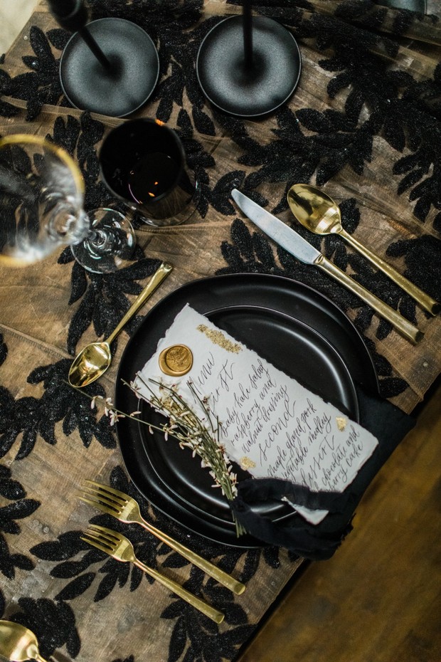 Elegant black and gold table setting with menu card
