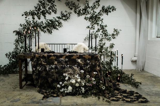 Elegant wedding table with black candles and floral decor