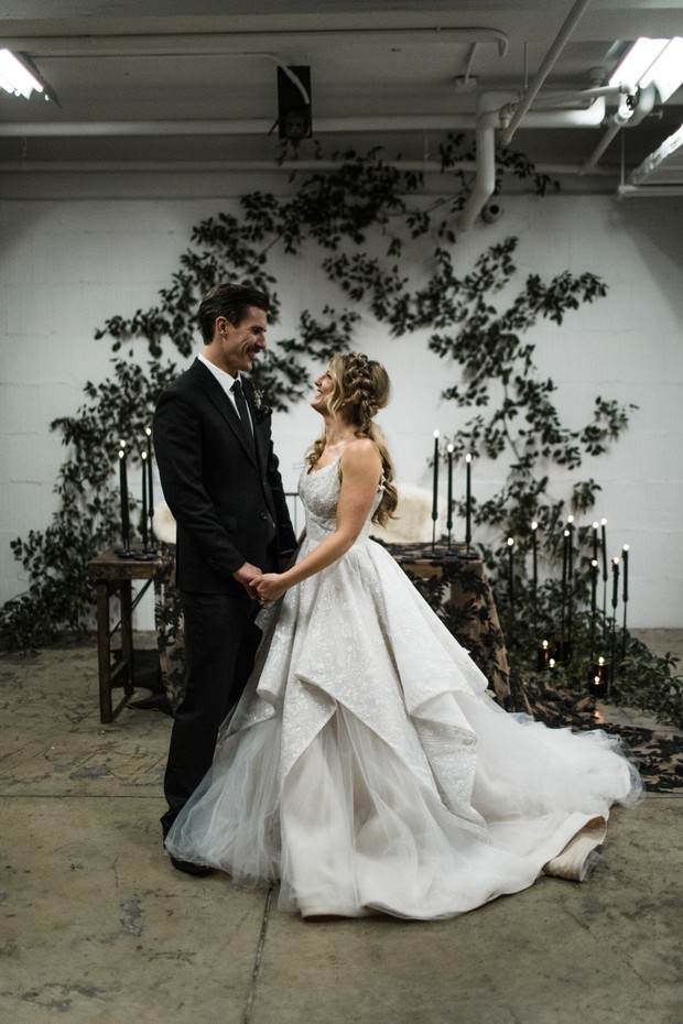 Groom and bride smiling at an elegant wedding venue