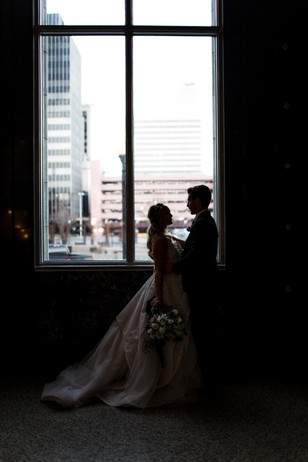 Silhouette of Bride and Groom by Window on Wedding Day