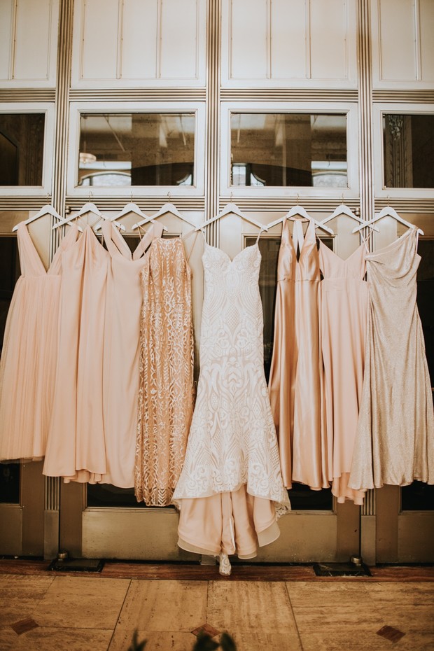 Bridal gown and bridesmaids dresses hanging together