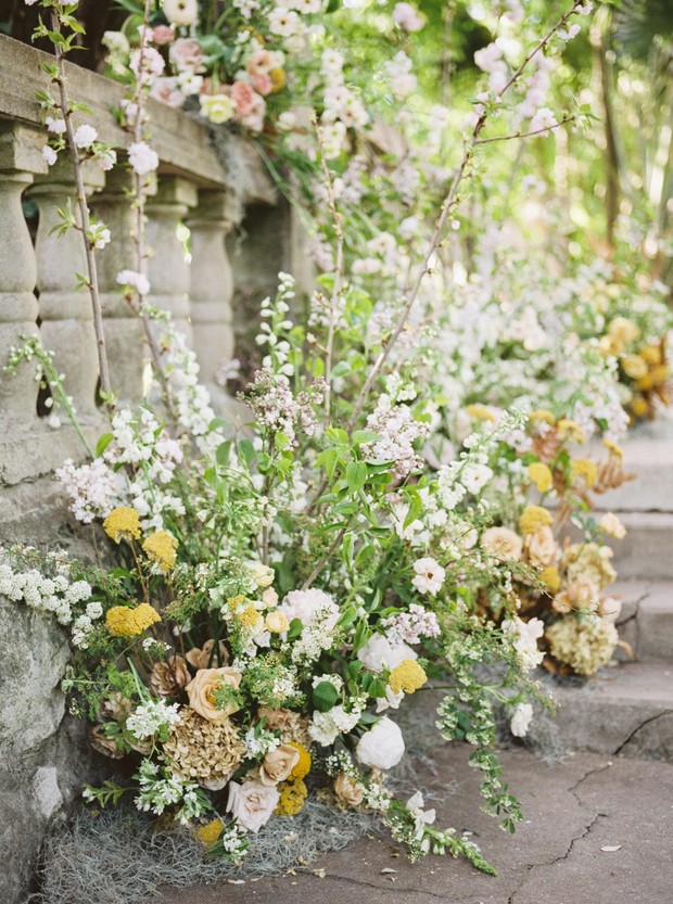 Floral wedding decorations on stone steps balustrade