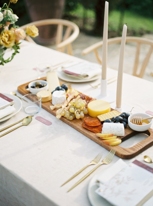 Elegant charcuterie board and candles on a set table