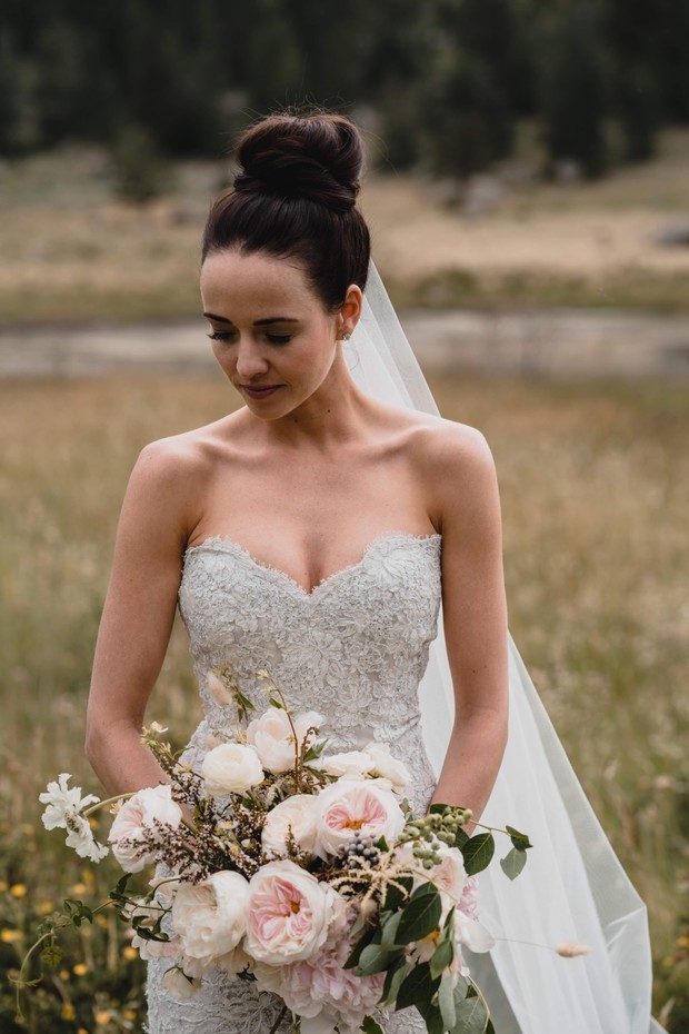 Bride holding beautiful wedding bouquet outdoors