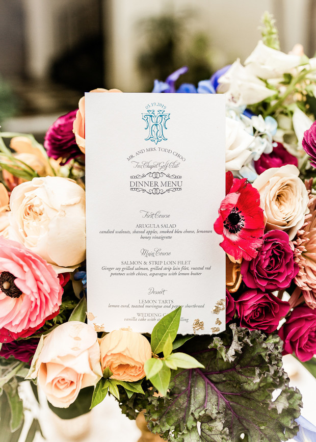 Wedding menu card amid colorful floral centerpiece