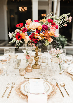 Elegant wedding table setting with bright floral centerpiece