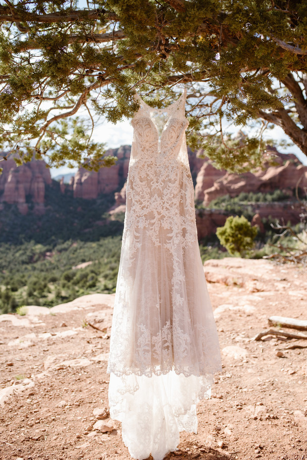 Lace wedding dress hanging from tree in Sedona Arizona