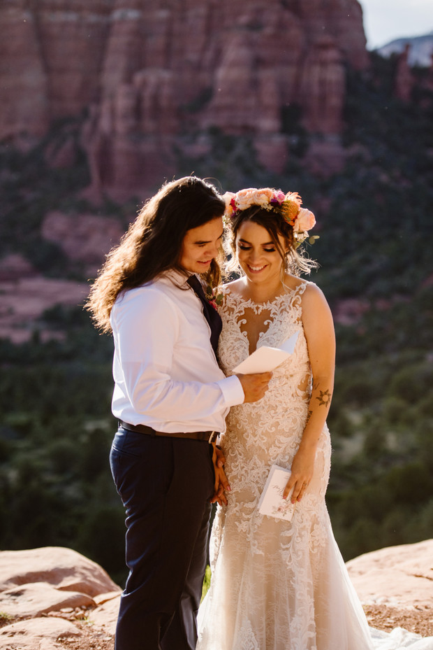 Bride and groom reading vows during outdoor ceremony