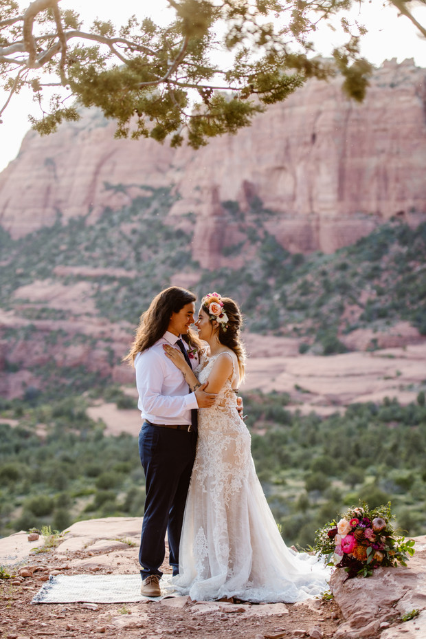 Bride and groom embracing at scenic Sedona wedding