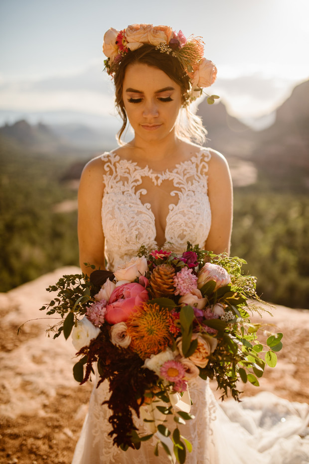 Beautiful bride with floral crown and bouquet outdoor