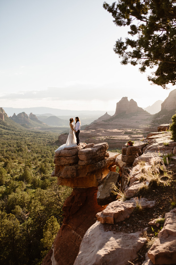 Bride and bride on stunning Sedona landscape rock cliff