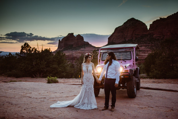 Bride and groom by pink Jeep at Sedona wedding sunset