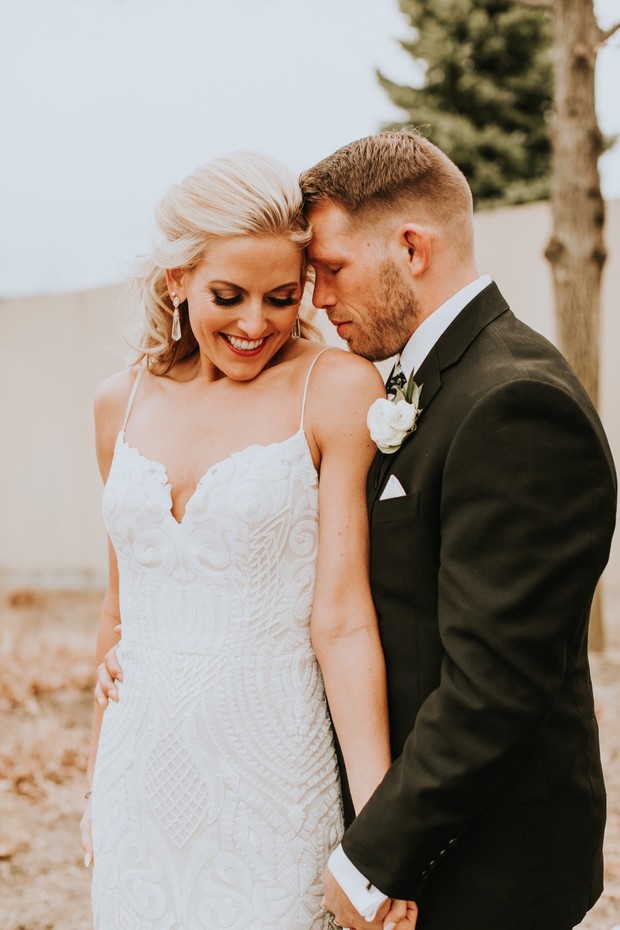Bride and groom lovingly embrace on their wedding day