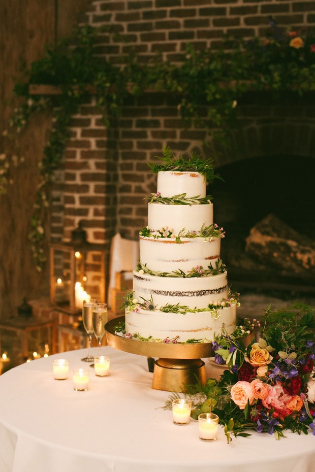 Elegant wedding cake with greenery and candles decor