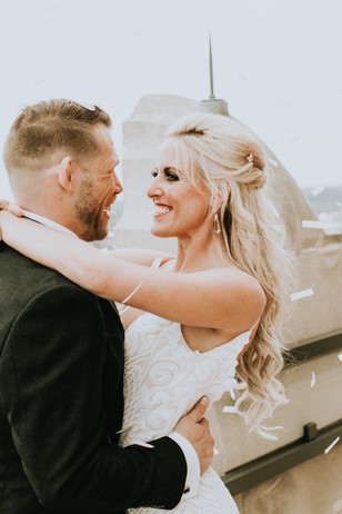 Smiling couple share loving embrace on wedding day