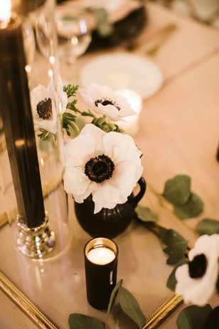 White anemone flowers and black candles wedding table decor