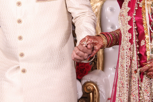 Bride and groom holding hands at their wedding