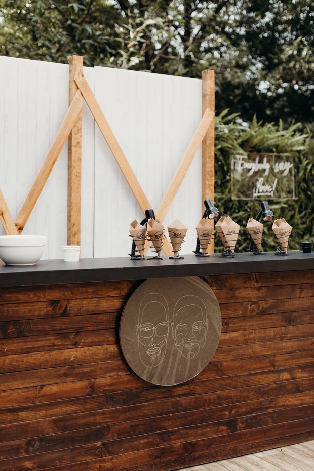 Rustic wedding ice cream bar with custom portrait sign