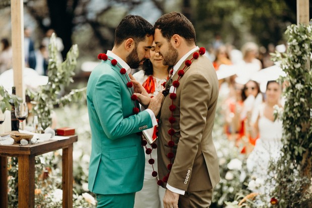 Two grooms forehead to forehead at their wedding ceremony