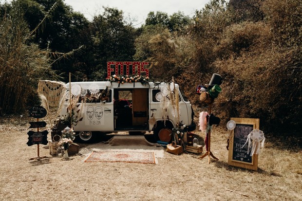 Vintage VW van photo booth at outdoor wedding party