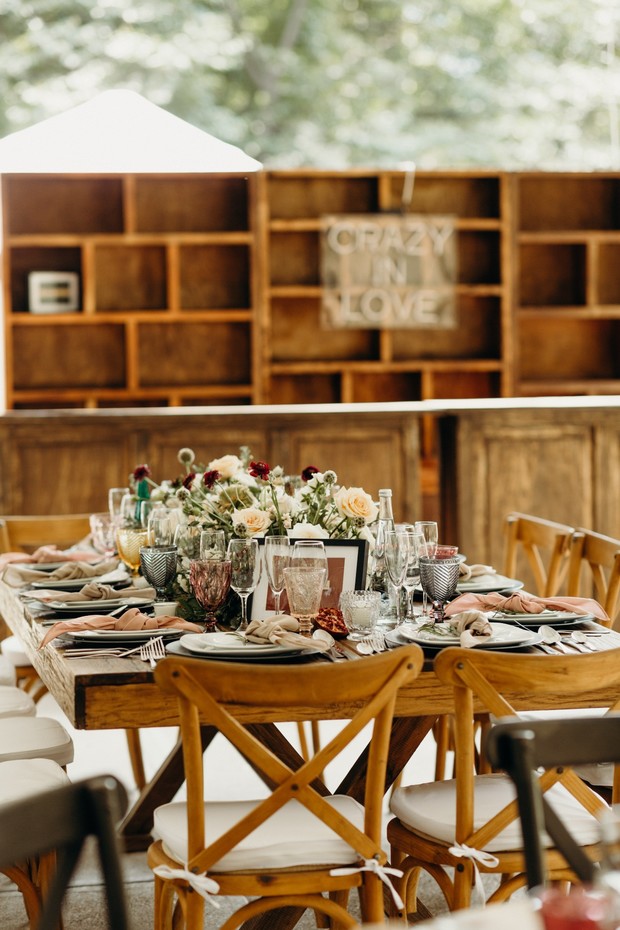 Rustic wedding reception table setting with floral centerpiece