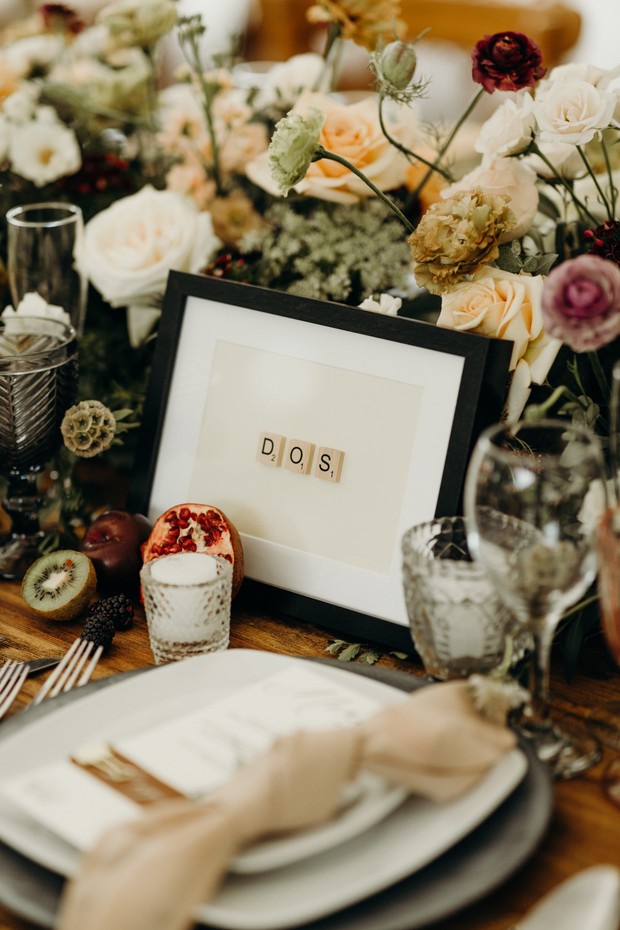 Elegant wedding table setting with flowers and number DOS