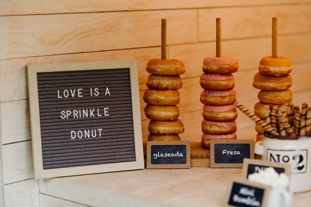 Donut bar with a sprinkle donut sign and donut stacks