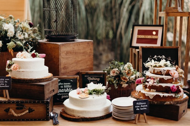 Rustic wedding dessert table with cakes and floral decor