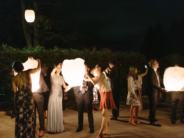 Friends and family releasing luminous lanterns at night