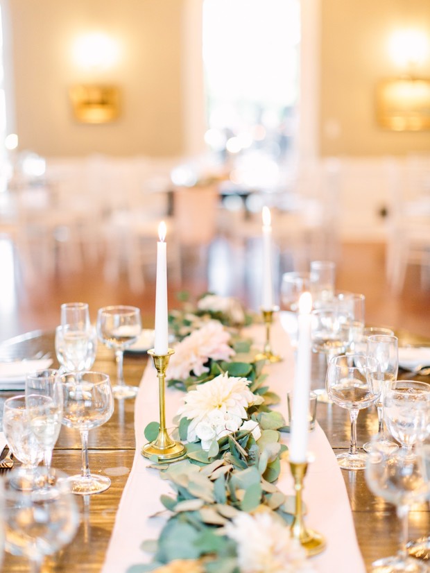 Elegant wedding table setting with flowers and lit candles