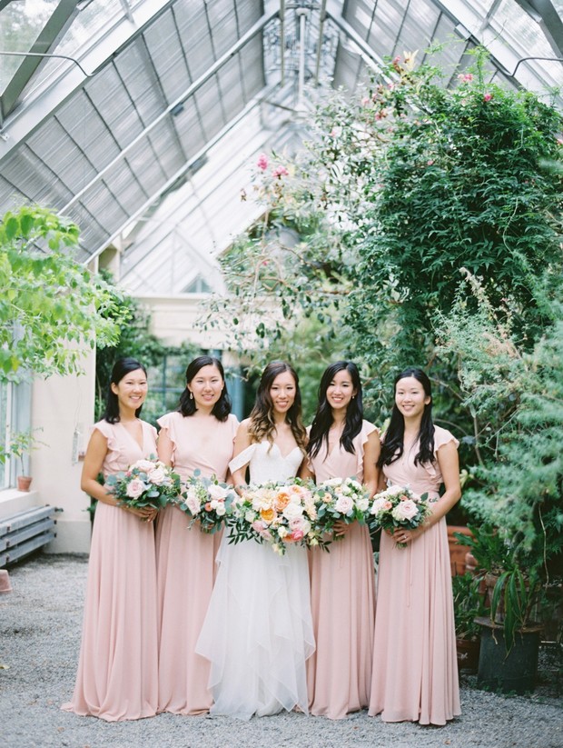 Bride and bridesmaids in pink dresses with bouquets