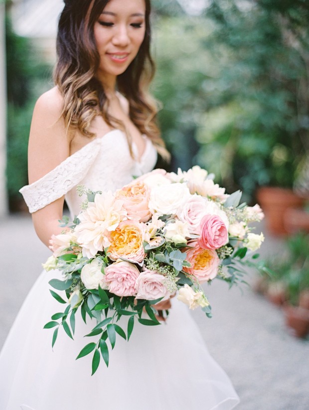 Asian bride with a blush and peach wedding bouquet