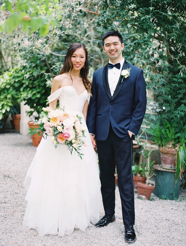 Bride and groom posing outdoors on their wedding day