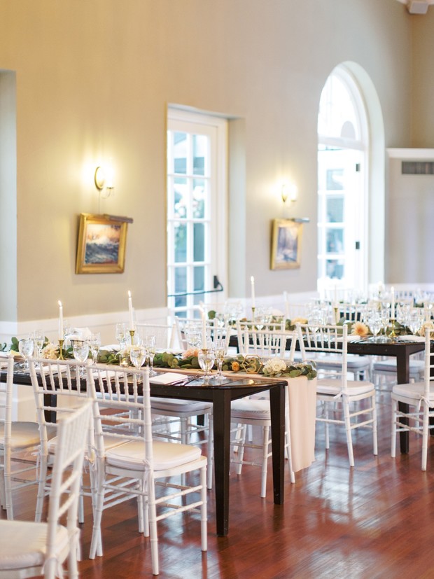 Elegant wedding reception venue with decorated tables and chairs