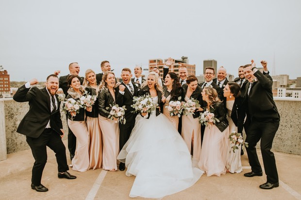 Joyful bride and wedding party rooftop celebration