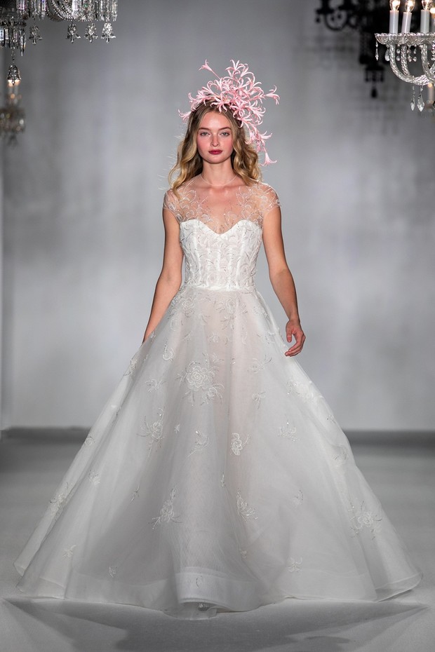 Bride in white ball gown with pink floral headpiece
