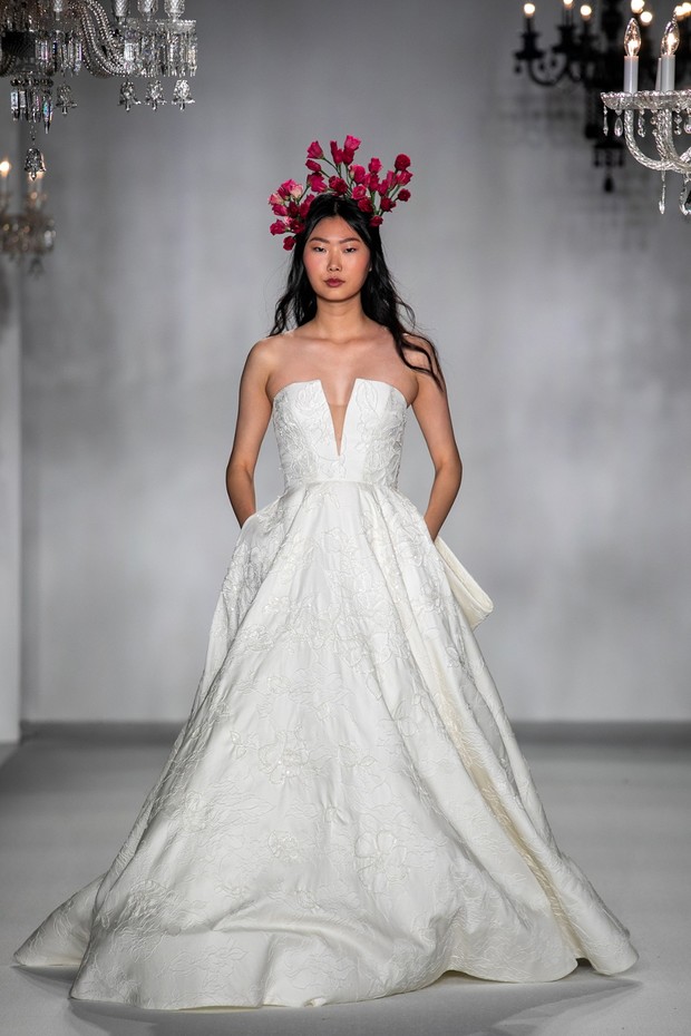 Model in embroidered wedding gown with flower crown
