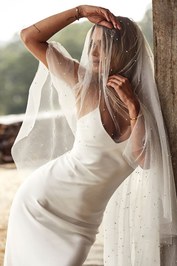 Bride in white dress and beaded veil wedding fashion