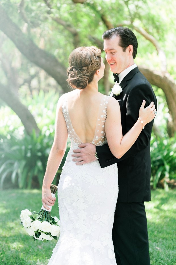 Bride and groom embrace on their wedding day outdoors